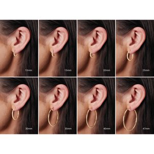 Classic 2 mm tube hoop earrings shown on ear in seven diameter sizes
